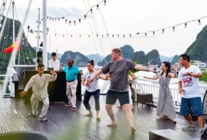 Morning Tai Chi session on sundeck of Hercules Grand Cruise in Halong Bay